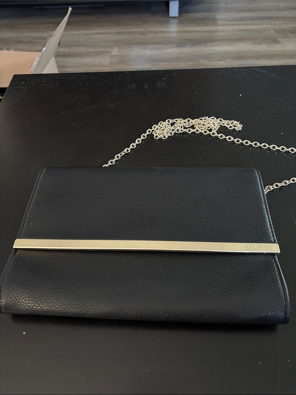GUESS Black Clutch with Gold Accent Bar and Chain